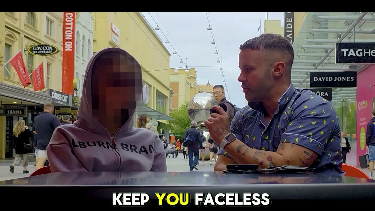 Mike interviewing a hooded creator in an Adelaide mall; the caption reads “KEEP YOU FACELESS”.